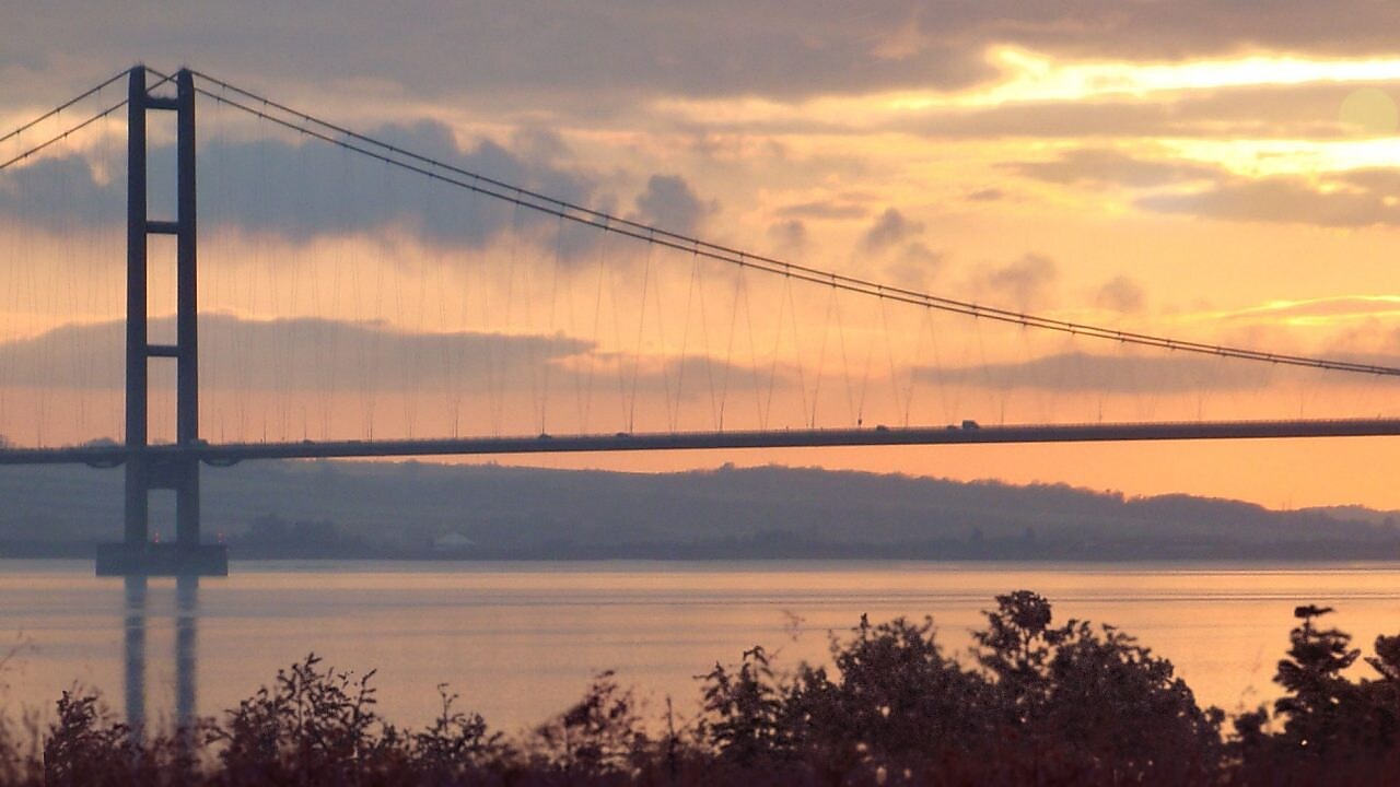  підвісний міст через річку у заході сонця