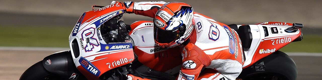 Мотоцикл з пілотом входить в поворот на гоночній трасі