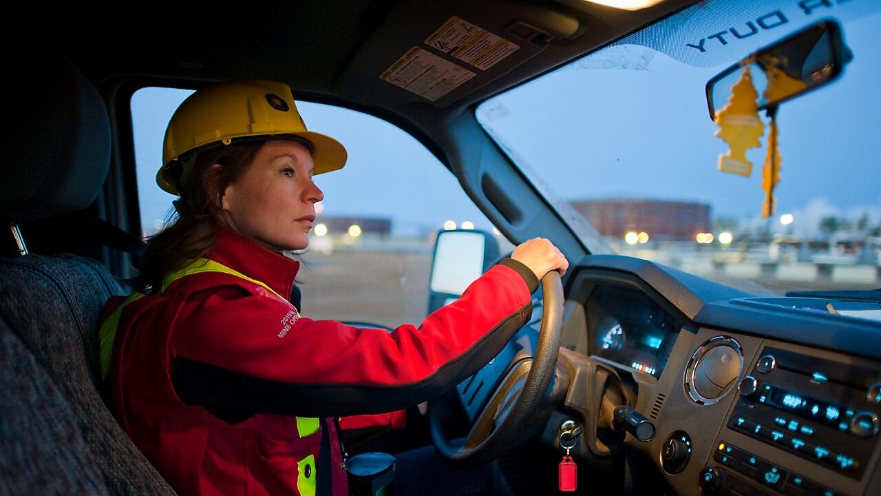 Жінка в захисному спорядженні за кермом транспортного засобу